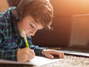 Young-boy-studying-with-tablet-at-home